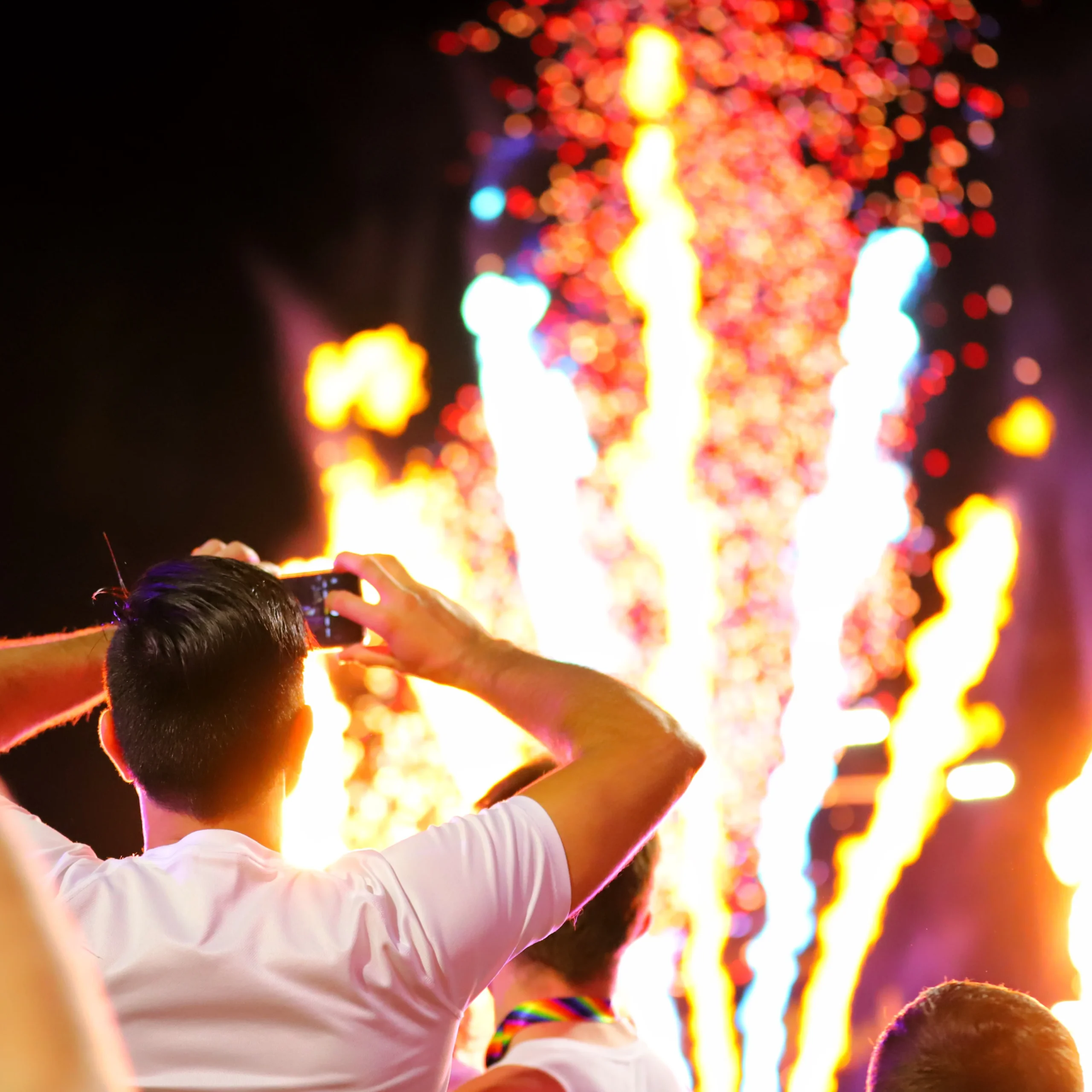 Image of a man watching fireworks at a festival
